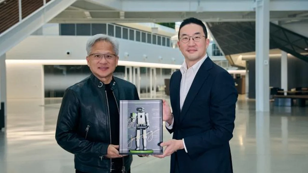 LG's Kwang Mo Koo and NVIDIA's Jensen Huang present a miniature humanoid model after signing their memorandum