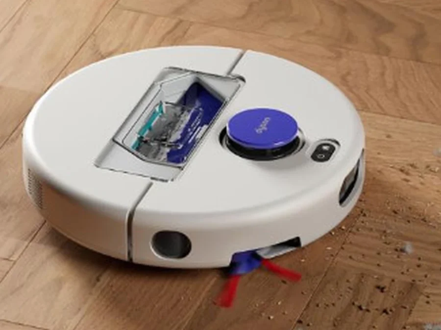Dyson R1 Nurovi robot vacuum cleaning debris on a wooden floor