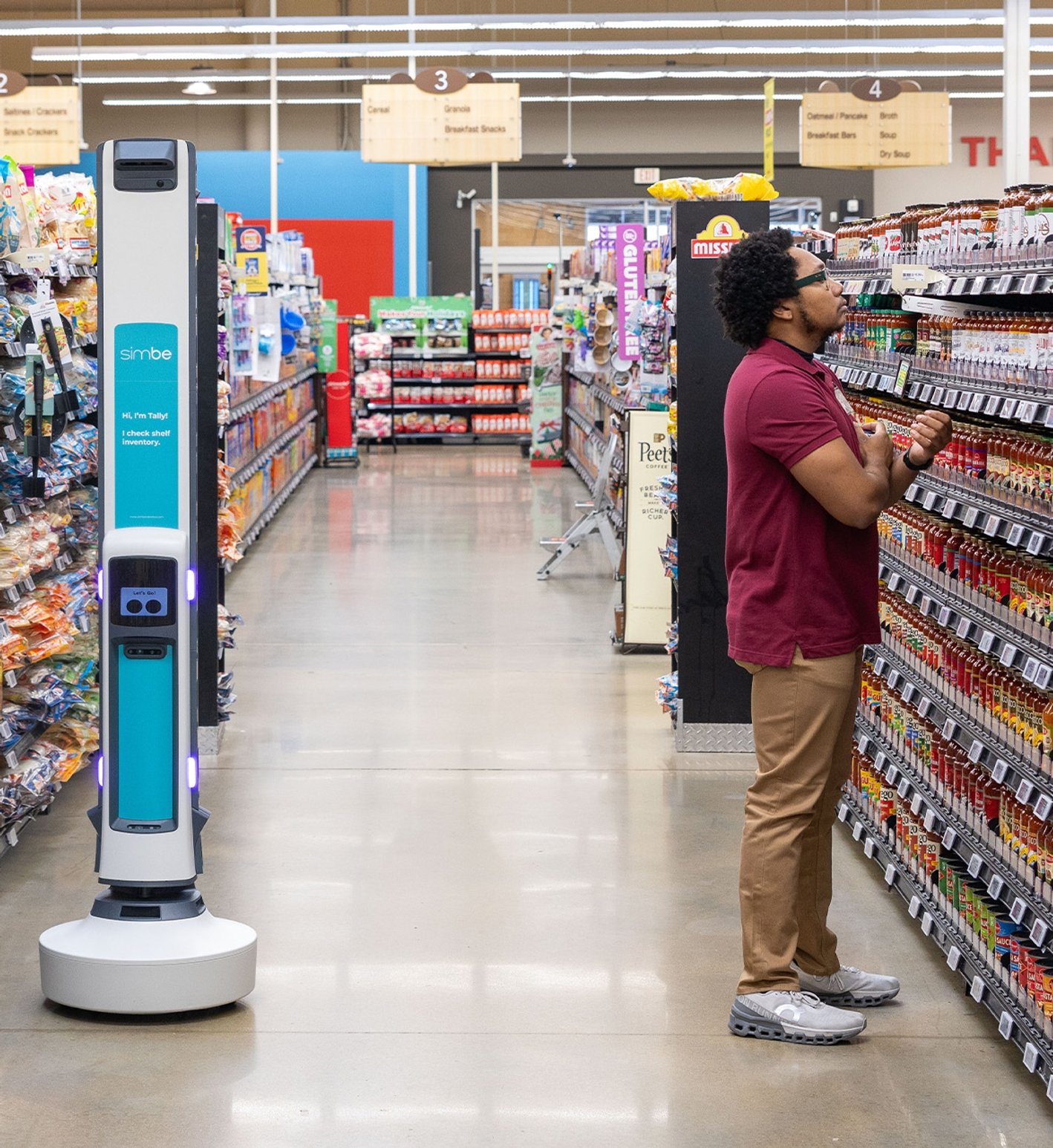 Simbe Tally robot operating in a grocery-store aisle