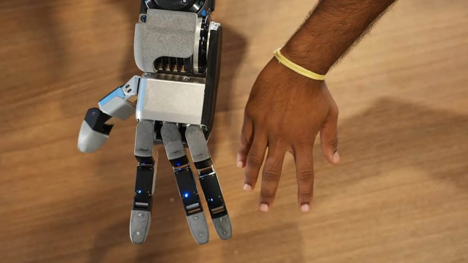 The new four-finger Atlas robot hand next to a human hand — official Boston Dynamics imagery