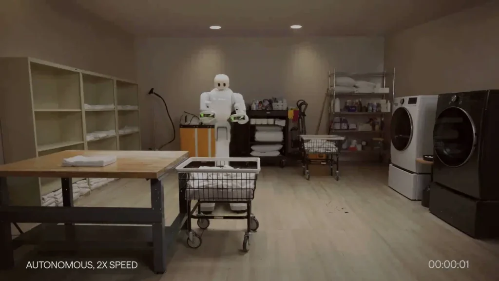 Taku working in a laundry room during the Dyna 2.1 autonomous workflow — official Dyna Robotics imagery