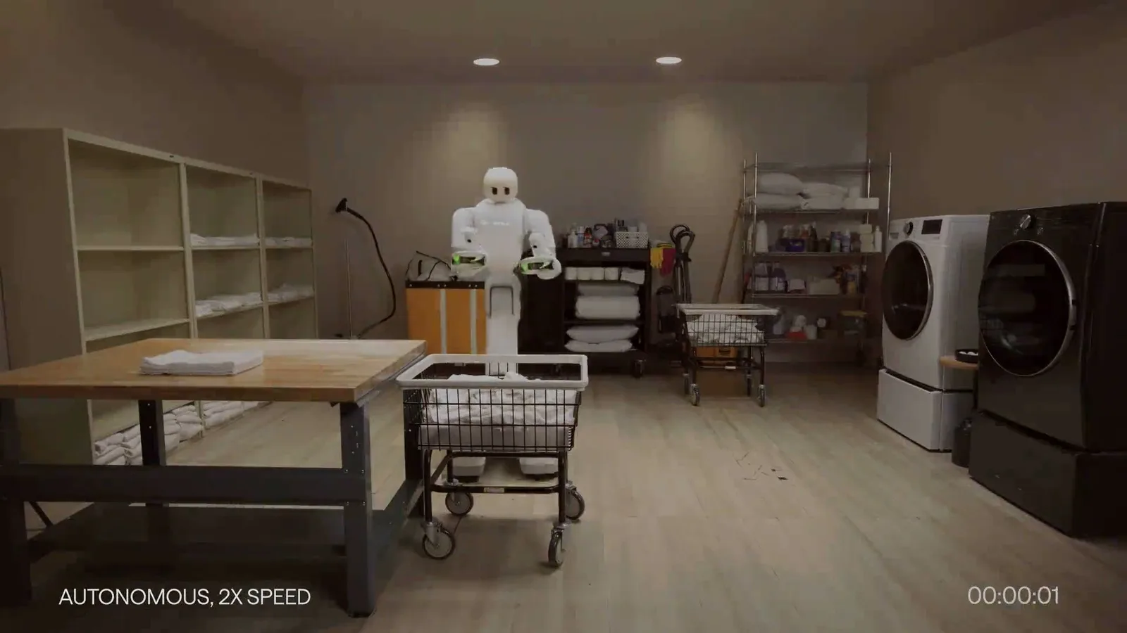 Taku working in a laundry room during the Dyna 2.1 autonomous workflow — official Dyna Robotics imagery