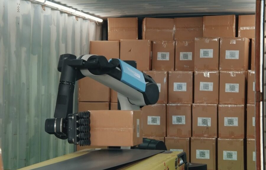 Stretch grips a carton beside a conveyor in the Hermes Fulfilment case study. Photograph: Boston Dynamics.