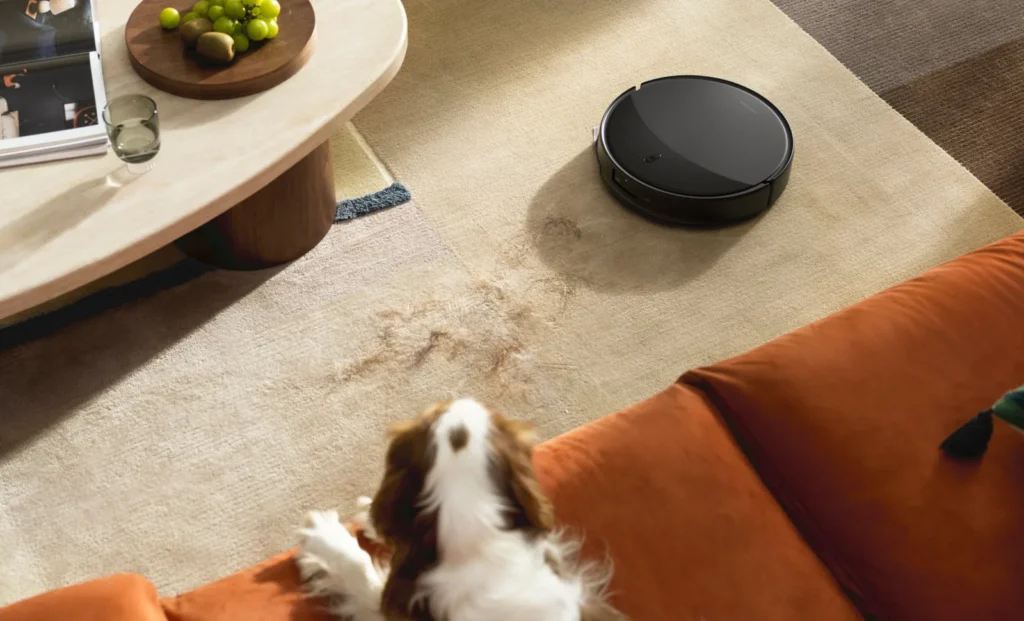 Roborock Saros 20 robot vacuum in a home near a pet