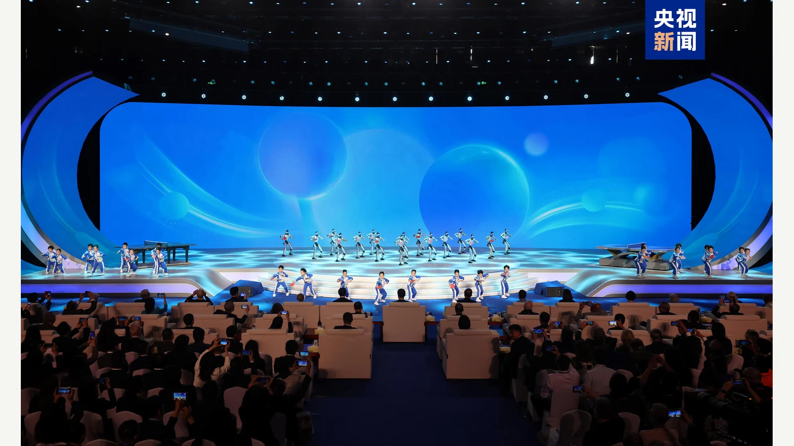 A group of Unitree humanoids on stage at a ping-pong diplomacy event; CCTV News image supplied by Unitree.